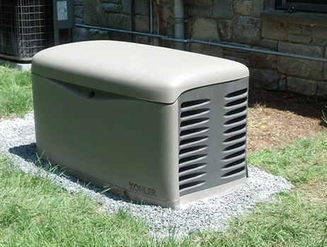 Generator installed outdoors on a gravel bed